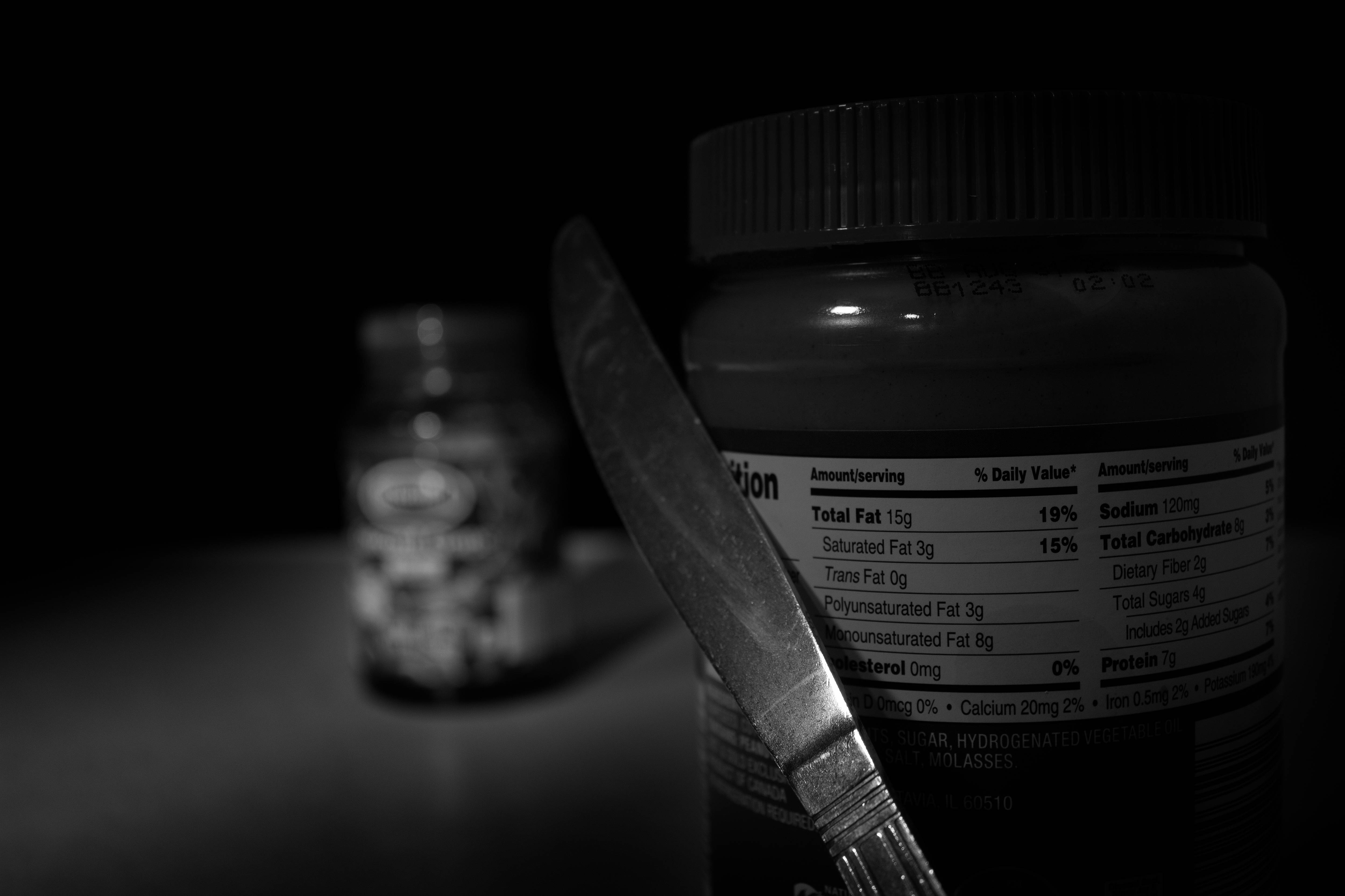 Peanut butter stalking jelly with a knife.